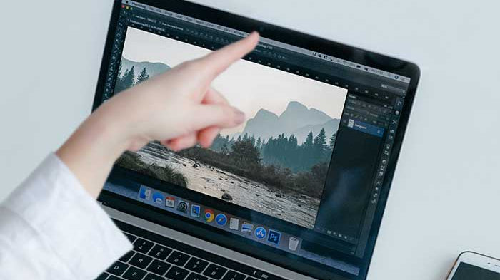 Best Reusable Webcam Covers in 2026. Person pointing her finger at the webcam on on a laptop
