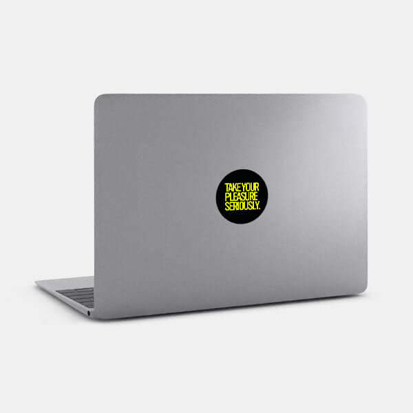 neon yellow take your pleasure seriously reusable macbook sticker tabtag on a laptop