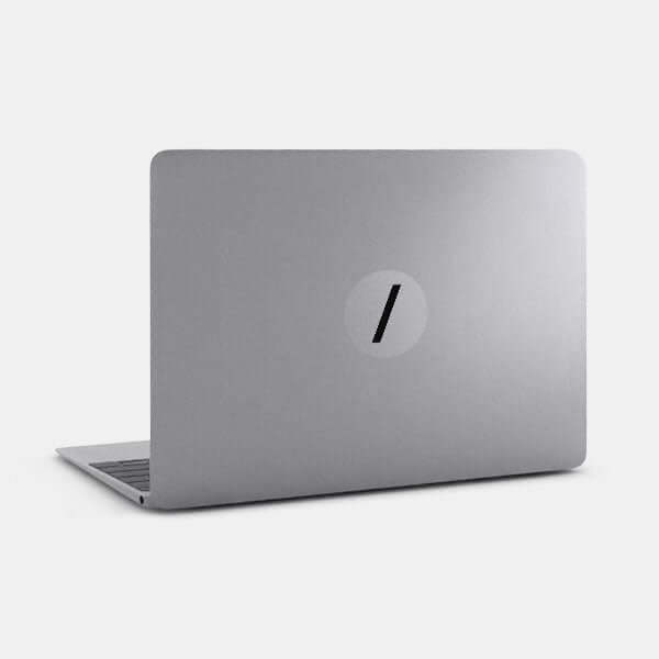 spacegray slash reusable macbook sticker tabtag on a laptop