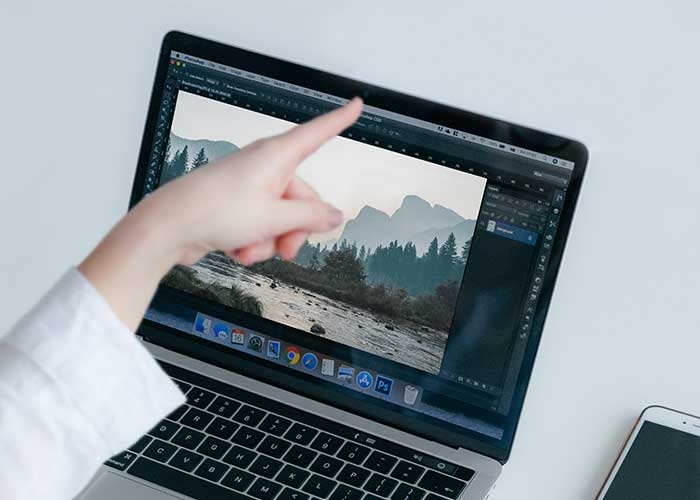 Best Reusable Webcam Covers in 2026. Person pointing her finger at the webcam on on a laptop