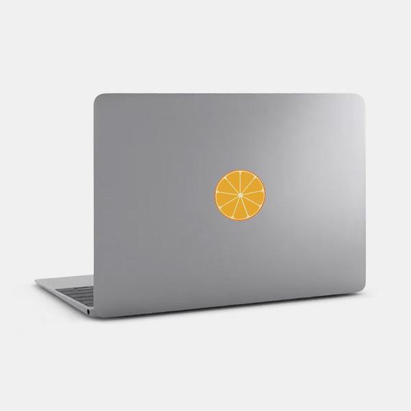 orange tabtag reusable macbook sticker tabtag on a laptop