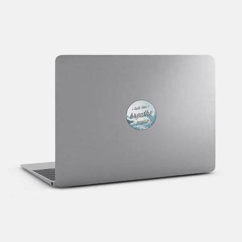 typographic "talk less / breathe more" reusable macbook sticker tabtag on a mac
